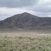 The West Face of Peak 6570 as viewed from the parking spot. A prominent gully splits the West Face. The West Ridge—NORTH follows the ridge just L/N of this gully. The West Ridge—SOUTH Route follows the ridge just R/S of this gully. Livingston Douglas Photo