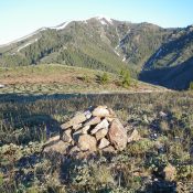 The summit cairn atop Peak 7536 with snow-clad Kelly Mountain (8,826 feet) in the distance. Livingston Douglas Photo