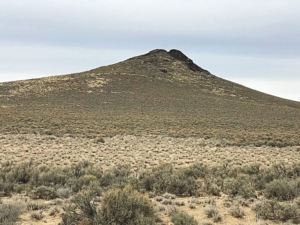 Peak 5565 resembles a volcanic cone but is simply a remnant of a sedimentary uplift.