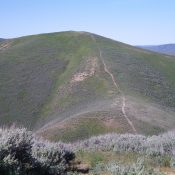 Peak 6725 as viewed from high on Della Mountain. An old jeep track weaves its way up the Northeast Ridge. Livingston Douglas Photo