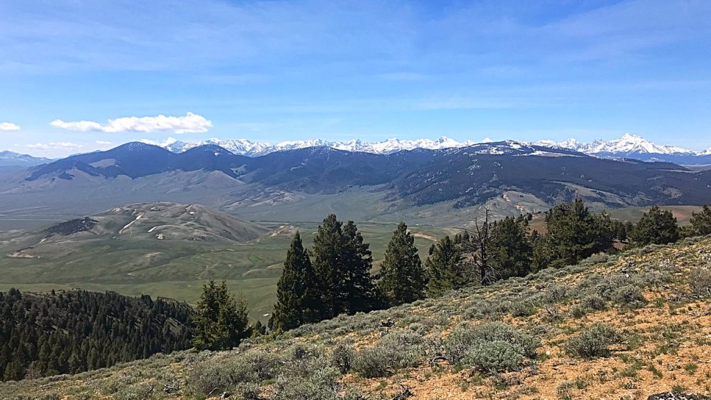 The Donkey Hills with the Lost River Range in the background as viewed from the Lemhi Range. Donkey Benchmark is the peak with snow on the rigjt side of the photo.