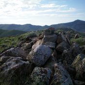 The summit cairn atop rocky Peak 6390 with Pine Mountain in the background (right of center). Livingston Douglas Photo
