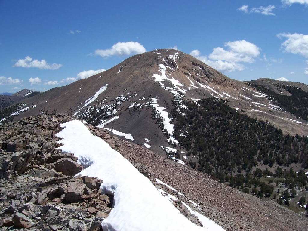Yellow Peak is a main crest summit in the central section of Lemhi Range. It is the 7th highest 10'er in Idaho. On my 6/25/94 visit, made note that the yellowish rock is not exotic, just brown iron stained quartzite. Re-erected wooden target signal. USGS benchmark 1956, probably set by J. Clark. View N on 6/15/07. Rick Baugher Photo