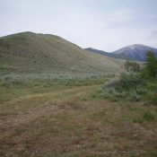 The Southwest Ridge as viewed from its base. The initial scrub hill/ridge is left of center. The summit of Peak 9188 is the forested point in dead-center. Sheep Mountain is right of center in the distance. The Southwest Ridge essentially goes all the way to the top of Sheep Mountain. Livingston Douglas Photo