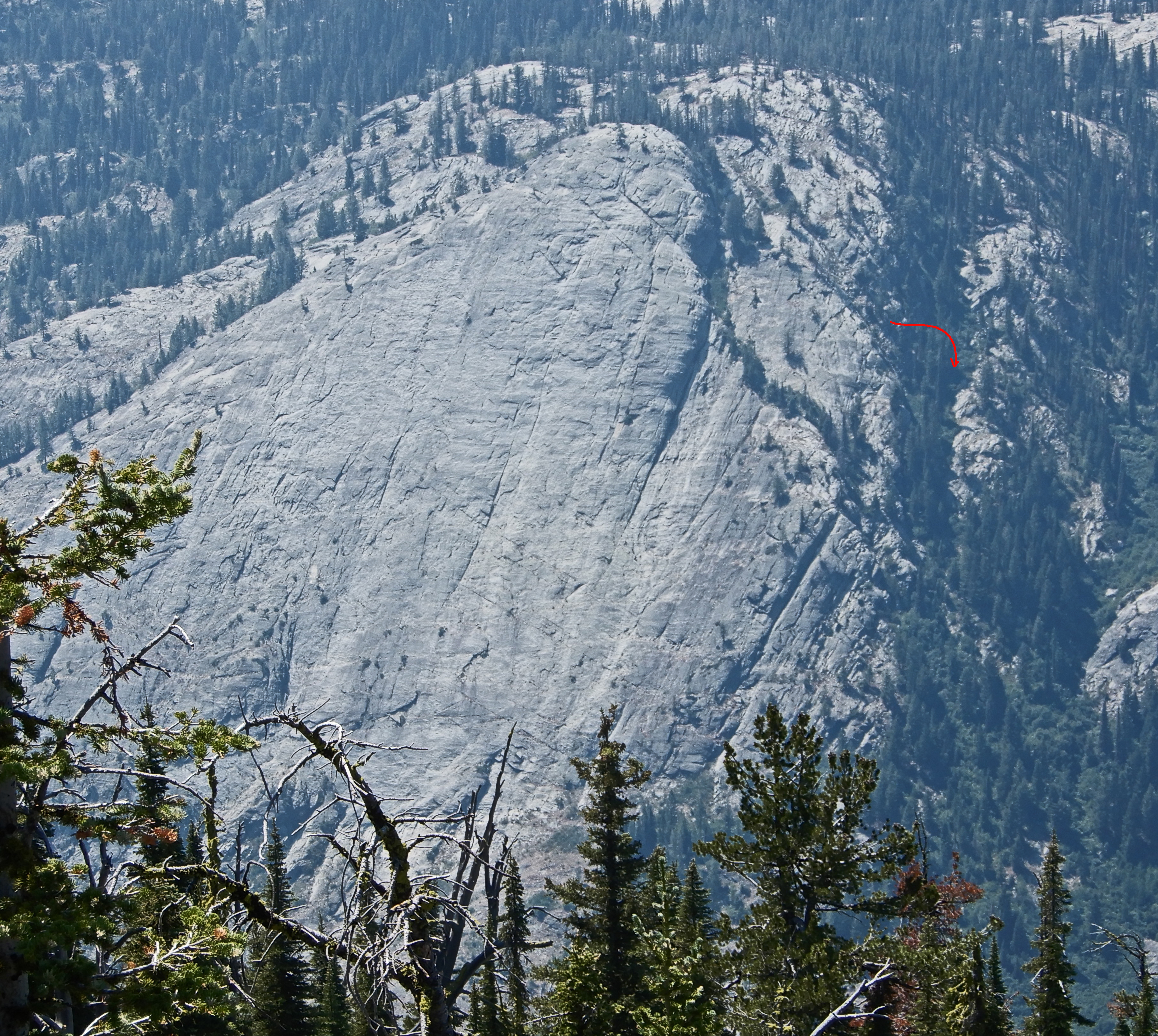 This photo is from (or near) Golden lake Peak. It shows the texture and features of the rock well, and also the descent gully, which is tricky to get into. You don’t want to follow the snaky line of trees- that can require a rappel. Instead, you follow the lightly-treed ramp above by turning an in-obvious blind corner. John Platt Photo