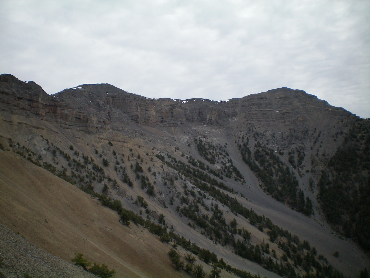 Shril Benchmark (left) and its connecting ridge to Point 10601 (right) as viewed from the southwest. The peaks appear, and are, of similar height. There is a gentle, albeit rocky, saddle between them. Livingston Douglas Photo 