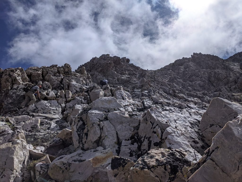 Climbing up the west face roughly 200 feet below the summit. Bill Manny Photo