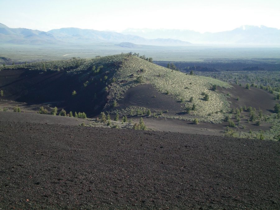 The East Face of Big Craters as viewed from the summit of Inferno Cone. The craters are on the far side of the hillside shown on the photo. The summit high point is just behind the trees, on the East Rim. Livingston Douglas Photo
