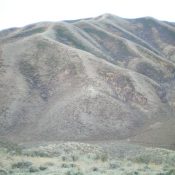 Peak 6883 is a behemoth as viewed from the east. The east ridge is left of center. The summit is the hump just right of center. Livingston Douglas Photo