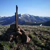 The summit cairn atop Peak 7900 with Blizzard Mountain in the background. The high point on Blizzard Mountain is the rightmost of the two humps. Livingston Douglas Photo