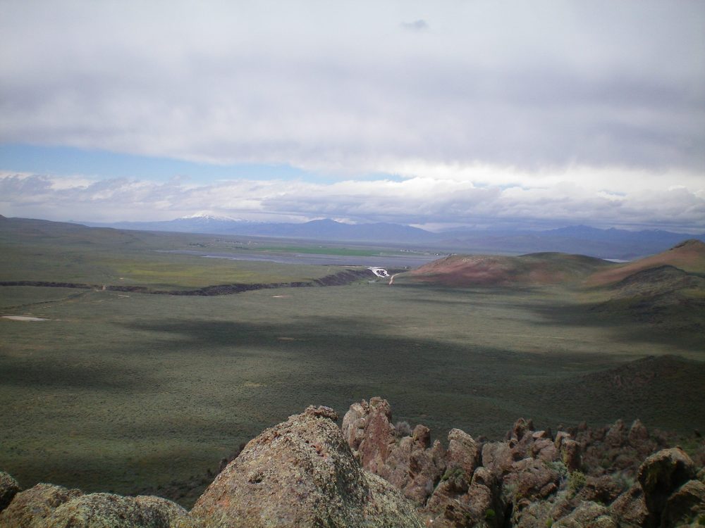 View of Magic Reservoir and its rushing outflow creek (in dead center, white) from the summit of Dinosaur Ridge. Livingston Douglas Photo