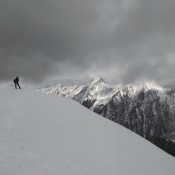 This approach was from Geertson Creek. From the BLM ownership there is more than one option to gain the main south approach. The route is mostly off trail hiking and an old two track that aids in getting to the south ridge. The route begins in the desert with sage brush to work around, then enters into the Douglas fir forest and finishes in the whitebark pine and subalpine fir. The route gains elevation steadily but is straight forward with no technical sections. The weekend of June 22, was just following a snow event that left snow at the upper elevations of the Beaverhead. The front was leaving as we approached the peak. The peak is set back from the crest of the Beaverheads and offers amazing views of Monument, Three Sisters, and Center Mountains. Looking North and east offers views of Freeman and into some Montana peaks. Looking down range you can see Goldstone Peak and down toward Goat Mountain.