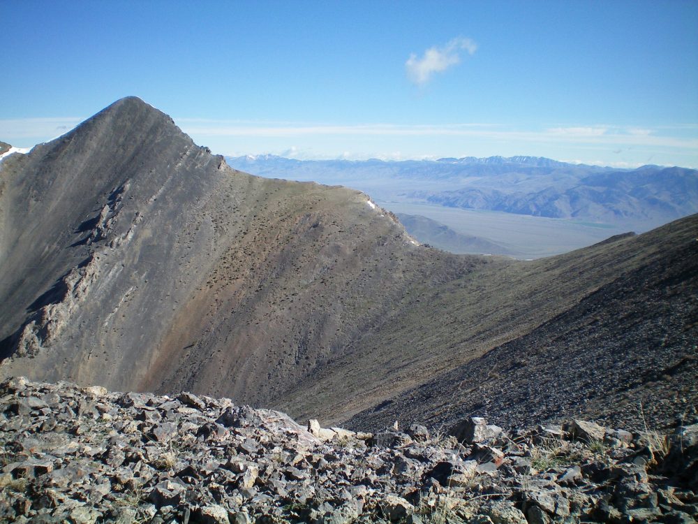 Tyler Peak (left of center) and its choppy Southeast Ridge (skyline), as viewed from the West Ridge of Mount Hoopes. The saddle is the low point between Tyler Peak and Mount Hoopes. Livingston Douglas Photo 