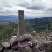 The summit cairn and post atop Walker Benchmark with rocky Point 6586 in the distance (just left of the cairn post). Livingston Douglas Philadelphia