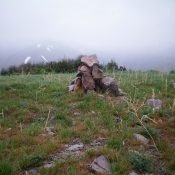 The newly-built summit cairn atop Peak 7058, on a cold, rainy morning in mid-May. Livingston Douglas Photo