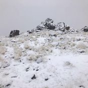 This outcrop is the highest point of Reynolds Peak. Circle around the north side where you will find a tall step that leads to the top. There is a summit register.