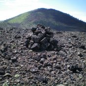 The summit cairn atop Broken Top with Big Cinder Butte in the background. Livingston Douglas Photo