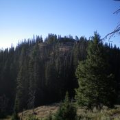 Dry Creek Peak (forested hump in center) as viewed from the ridge to its northwest. Livingston Douglas Photo