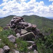 The summit cairn atop Peak 6025 looking south. Peak 6145 is the most distant hump right of center. The ridge traverse to get there is a tedious endeavor with lots of weaving and ups/downs. Livingston Douglas