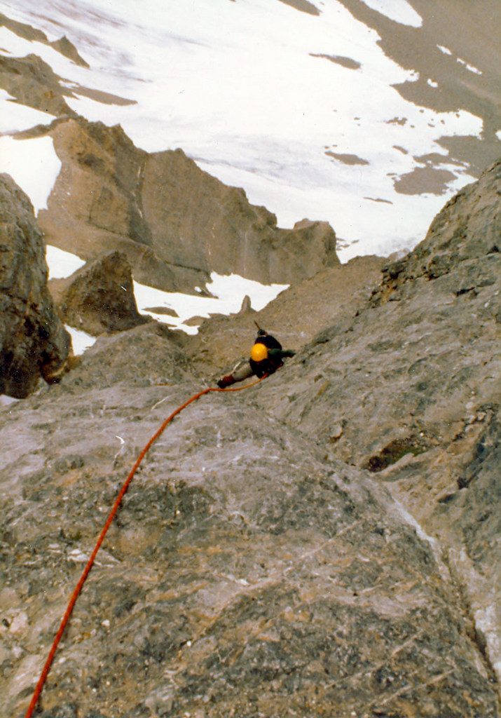 Mike on the rock band pitch between the two hanging snow fields. Photo - Curt Olson