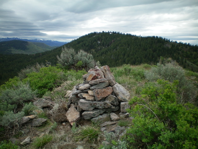 The newly-rebuilt summit cairn atop Peak 7042 with Peak 7283 in the background. Livingston Douglas Photo