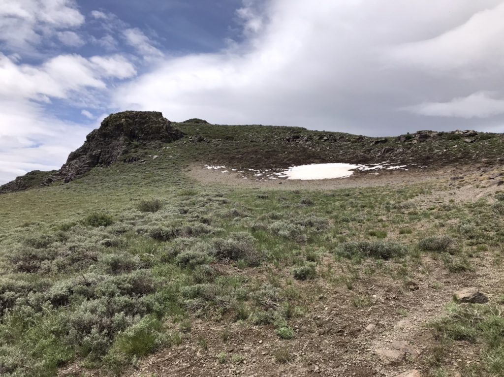 The rib melds into the peak’s east face. The easiest line climbs up just east of the Snowbank.