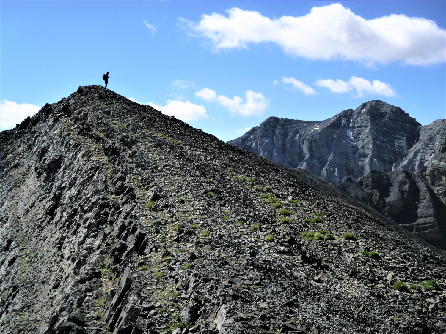 Alex on top of Peak 11,090 with Breitenbach in background.