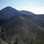 View of burn-scarred Peak 9151 (left of center, foreground) from the summit of Peak 9044. Saddle Mountain is in the distance. Livingston Douglas Photo