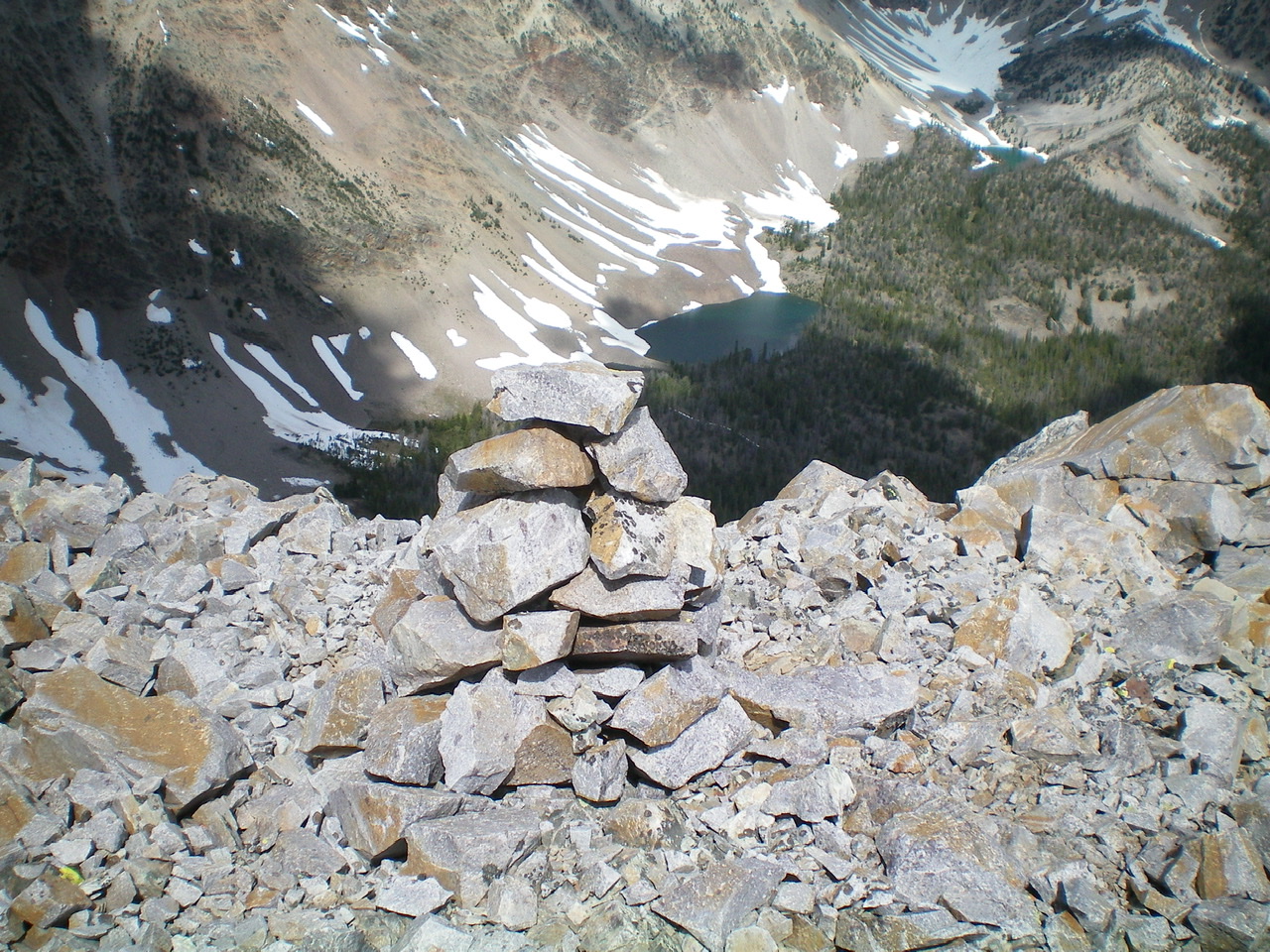 The summit cairn atop Peak 10310 with a beautiful high mountain lake to its northwest. Livingston Douglas Photo 