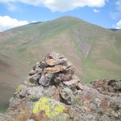 The summit cairn atop Peak 5764 with Peak 7900 in the background. Livingston Douglas Photo