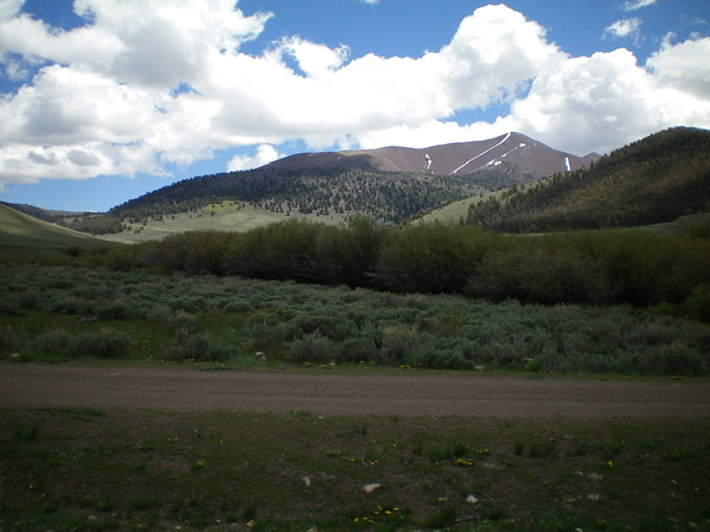 North Cabin Mountain (summit is right of center) and its magnificent north ridge (the bare rock ridge on the skyline) and northwest ridge (the forested ridge in mid-ground), as viewed from Burma Road at Corral Creek. Livingston Douglas Photo 