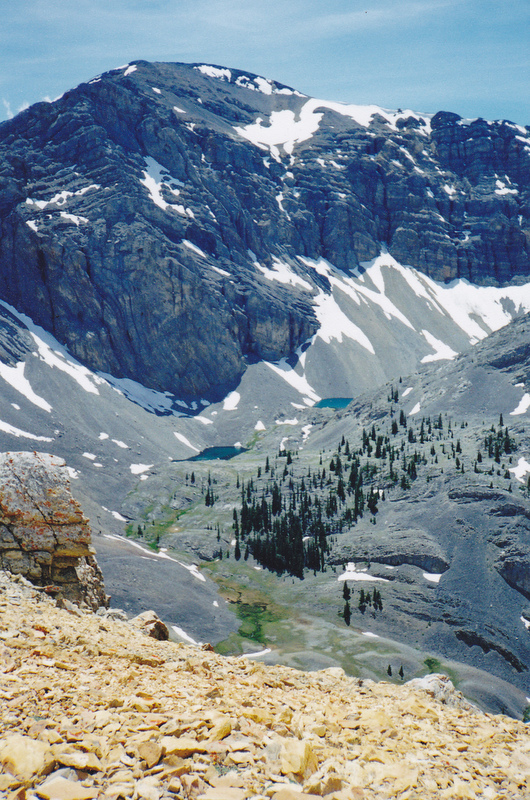 This shot was taken from the south end of Massacre Mountain at around the 10,800 foot level looking across Hell Roaring Canyon and Shadow Lakes to the north face of Clyde Ross Peak. Rick Baugher Photo 7-13-97