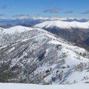 Summit of Little Kane Peak, mid-ground left. Photo - Steve Mandella.