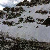 Early morning on the moraine below the North Face of Mount Borah. This (foreshortened) view from high on the moraine shows the extensive ice cover that existed at that time. October 1976. Photo - Bob Boyles