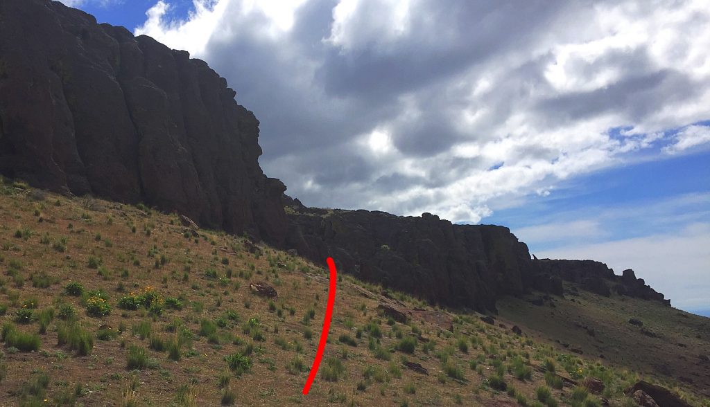 The cliff crown on the south side viewed from the west. The red line leads to the Class 2 opening in the cliffs.