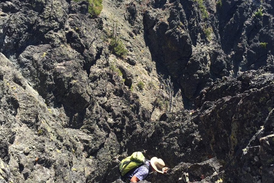 John making the final move over the cliff.