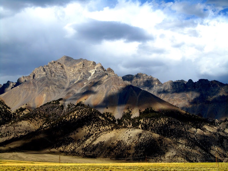 Paragon Peak is the peak hiding behind Lost River Mountains flank as viewed from US-93. George Reinier Photo