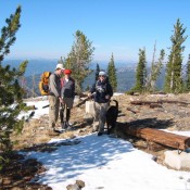 The summit of Boulder Mountain with three hikers and the sketchy remains of the fire lookout. John Platt Photo