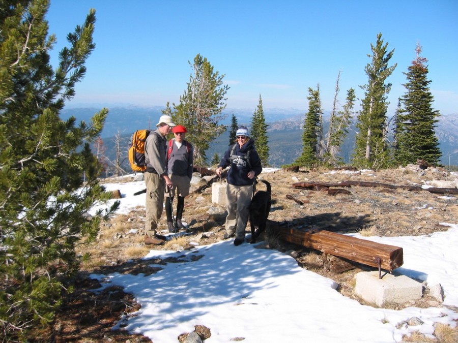 The summit of Boulder Mountain with three hikers and the sketchy remains of the fire lookout. John Platt Photo