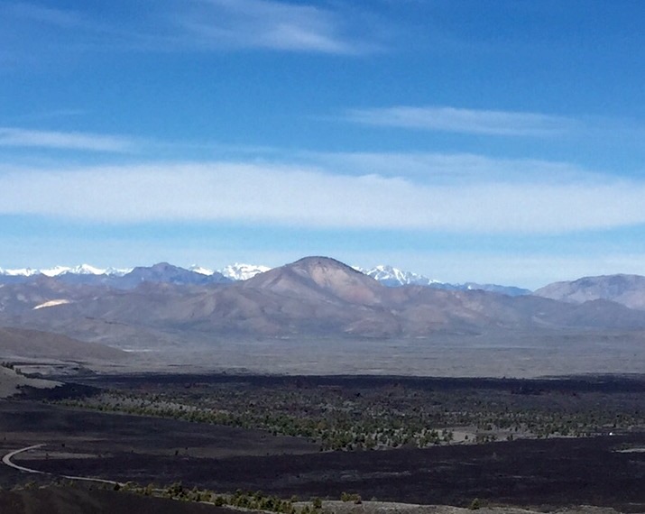 Timbered Dome from Big Cinder Butte in Craters of the Moon National Monument. The Lost River Range in the background and Sheep Mountain in the White Knob Mountains to its left. 