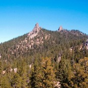 Needles Peak from the southwest. Three of the granite towers on this peak are visible in this photo. There are a large number of one and two pitch routes on these formation many of which were first climbed by Doug Colwell.