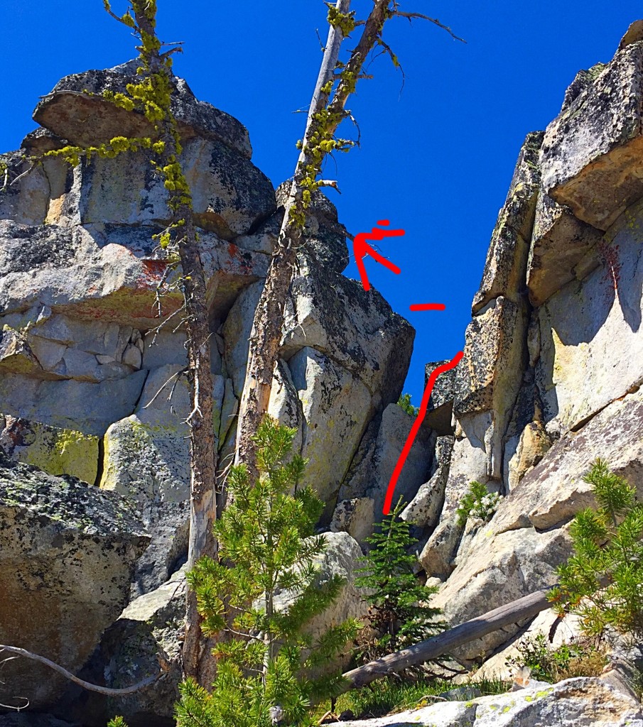 The west side of the summit block. The Class 4 route is shown in red. Climb the lower section on the right. Once on you reach the shelf at the top of the first move step across to higher block to the left and then scramble to the top. You can also climb the equally airy lower summit from the shelf.