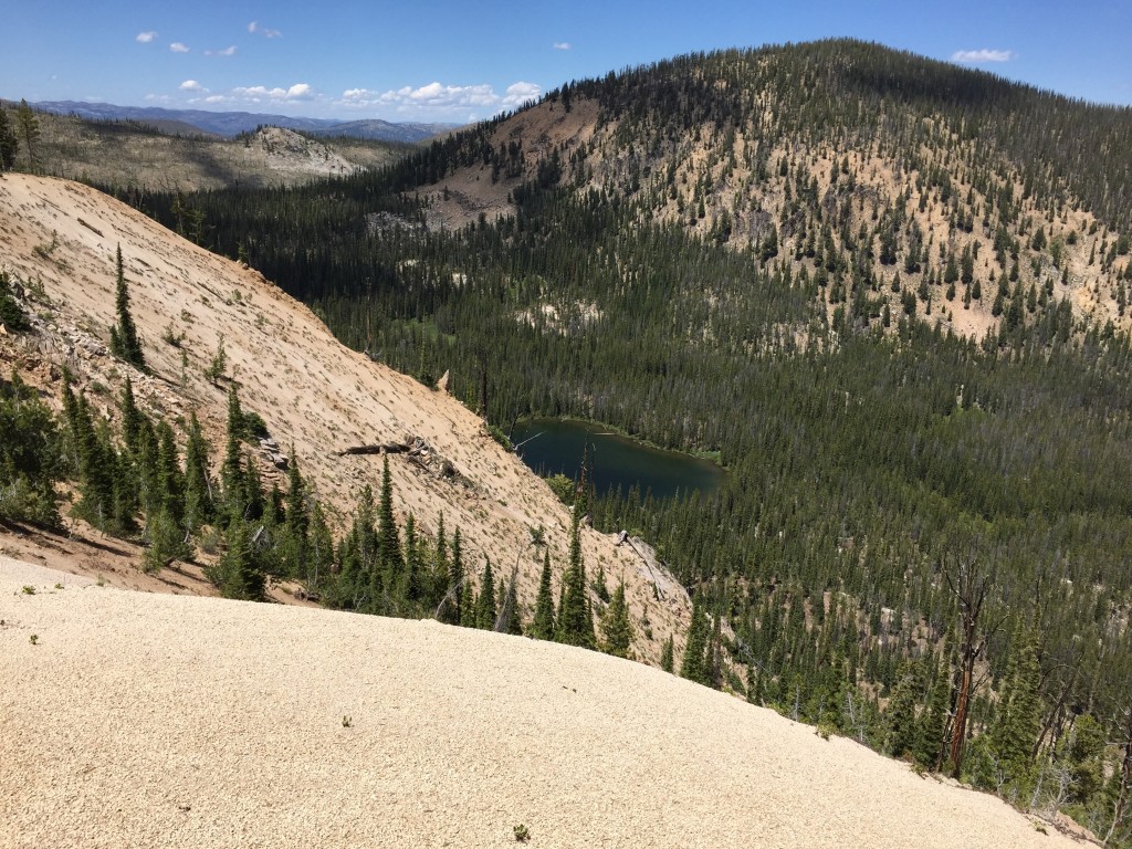 Around 8,000 feet the east ridge narrows. This photo shows an unnamed lake nestled into the ridge's north side.