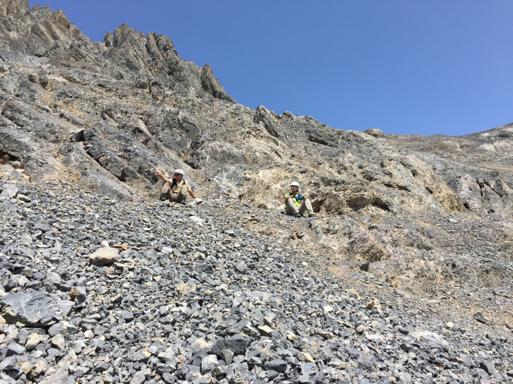 Taking a break at the point where the route leaves the talus and starts climbing talus covered slabs.