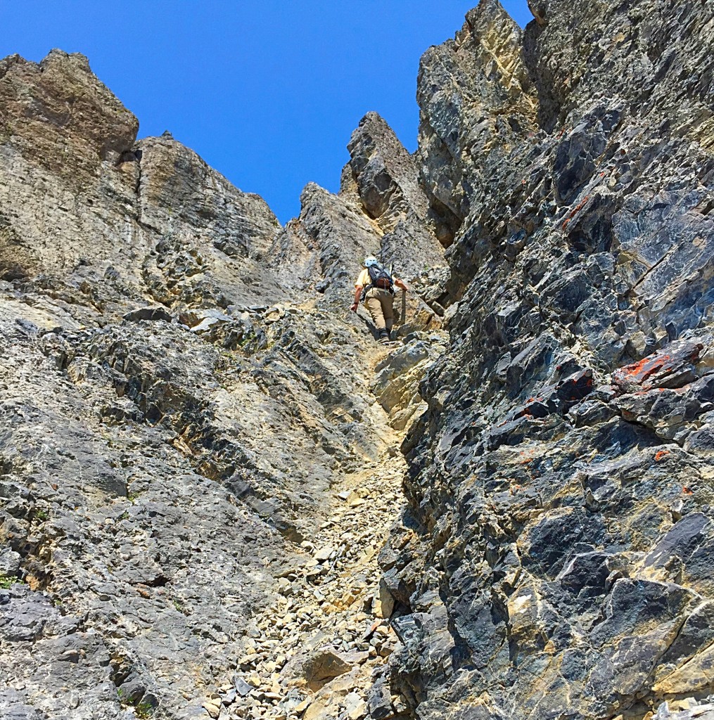 Larry Prescott mid-way up the gully. He is getting ready to move to his left where the rock is slightly less fractured.