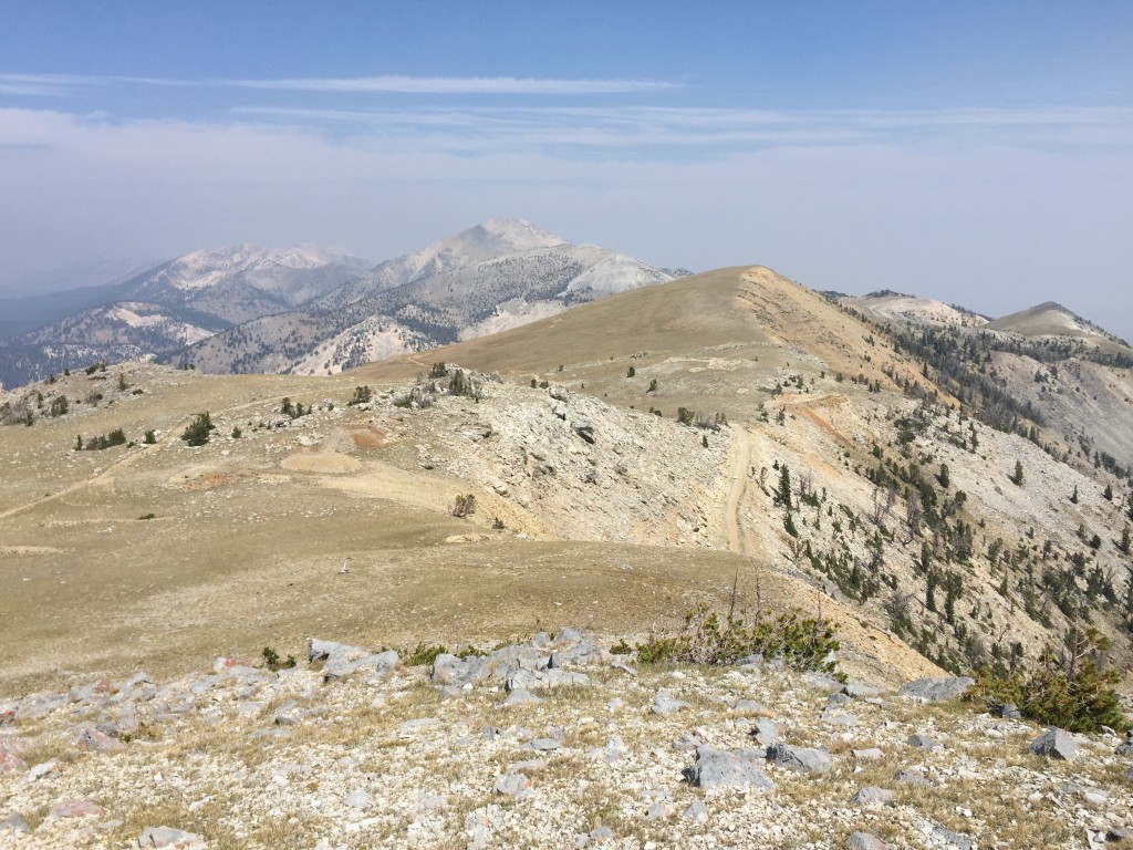 The highest point on the Spring Mountain Canyon Road is just north of the summit of Big Windy Peak. This photo shows the road reading the crest on the right side and proceeding north around the high point to,eventually meet with the Quartzite Canyon Road.